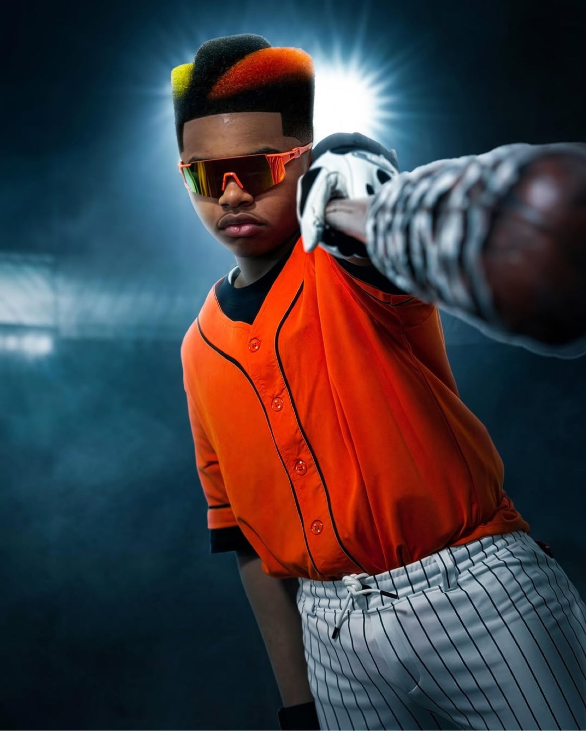 Barber art portrait with a geometric orange and black high-top hairstyle